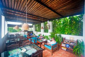 a restaurant with people sitting at tables in a patio at Inn Seventh Heaven in Pushkar