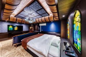 a bedroom with a bed and stained glass windows at Hotel Lotus Yokohama in Yokohama