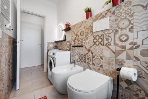 a bathroom with a toilet and a sink at Diamond House Holiday in Capiago Intimiano +17 photos
