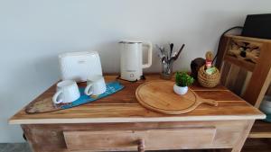 a wooden table with a coffee maker on it at Marilyn’s Resort Koh Samui in Lamai