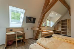 a bedroom with a bed and a desk and a window at Gutshof Colmberg in Colmberg +31 photos