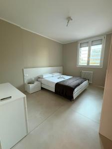 a bedroom with a large bed and two windows at Maggiore Panoramic Tower in Castel Maggiore +4 photos