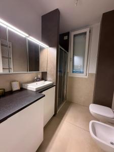 a bathroom with a sink and a toilet at Maggiore Panoramic Tower in Castel Maggiore