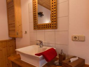 a bathroom with a sink and a red towel at Ferienwohnung Heimatgefühl Thalheim in Leibertingen +15 photos