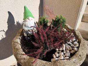 a garden gnome sitting in a flower pot at Villa Emilia nelle Dolomiti in Domegge di Cadore