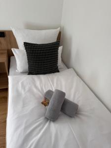 a white bed with two towels on top of it at Gasthof Kocherbähnle GmbH in Gaildorf