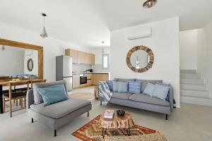 a living room with a couch and chairs and a table at Selinofos in Naxos Chora