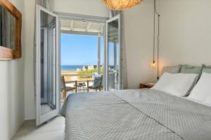a bedroom with a bed and a view of the ocean at Selinofos in Naxos Chora
