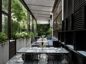 a patio with tables and chairs on a building at Shanghai Shang Ying CHAO Hotel in Shanghai