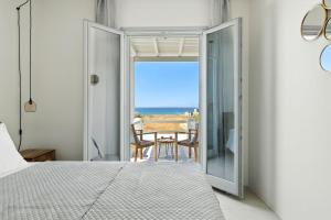 a bedroom with a bed and a view of the ocean at Selinofos in Kastraki
