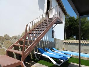 a deck with lounge chairs next to a swimming pool at Casa El Duque Leire in Vejer de la Frontera