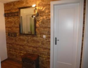 a brick wall with a mirror and a stool at Ferienwohnung Pusteblume in Forbach