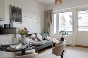 a living room with a couch and a table at Modern Aurora Apartment with Sauna - Rovaniemi by Book Lapland in Rovaniemi