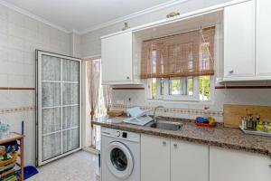 a kitchen with a sink and a washing machine at Villa is located about 700 meters from the beach !!! in Ban Lamai