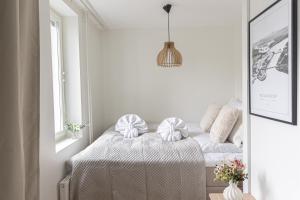 a bedroom with a bed and a mirror at Modern Aurora Apartment with Sauna - Rovaniemi by Book Lapland in Rovaniemi +11 photos