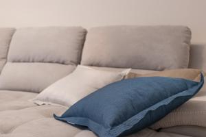a blue pillow sitting on top of a couch at V B M apartment in Bari