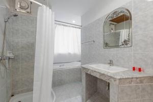 a bathroom with a sink and a shower at Break Point Patong Hotel in Patong Beach