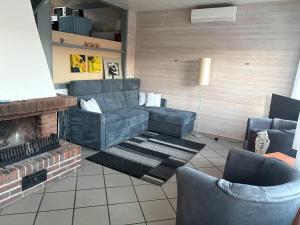 a living room with a couch and a fireplace at Sternschnuppe in Kirchheim