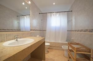a bathroom with a sink and a toilet and a shower at Casa Can Alou in Portocolom +34 photos