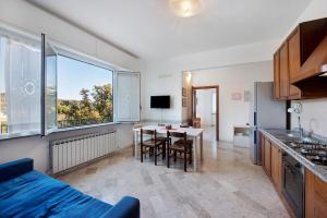 a kitchen and dining room with a table and a window at Tramontana in Celle Ligure