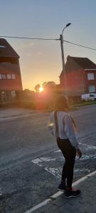 a girl is standing on the side of the street at Cute & Spacious 2 BDR condo in Montréal