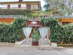 a sign for a hotel in front of a building at Hotel MonteMorello in Castiglione