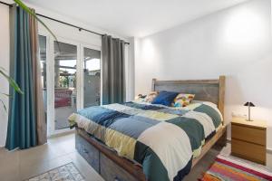 a bedroom with a bed and a sliding glass door at Villa Indie in Chiclana de la Frontera +26 photos