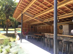 an outdoor patio with a bar with tables and chairs at Calama Selva Vitrac in Vitrac