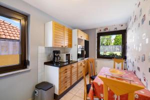 a small kitchen with a table and a dining room at Ferienwohnung Eleonore in Meßstetten