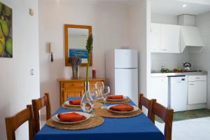 a dining room with a table with a blue table cloth at Apartamento Es Trenc 2 in Colonia Sant Jordi +6 photos