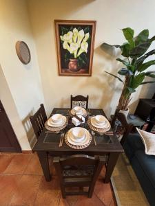 a dining room table with plates on it at Cozy Loft & Terrace in Antigua in Antigua Guatemala