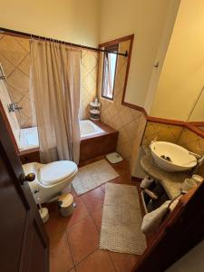 a bathroom with a toilet and a sink and a tub at Cozy Loft & Terrace in Antigua in Antigua Guatemala +18 photos