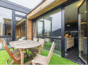 a dining room with a table and chairs on a patio at Chalet du Saix in Châtel