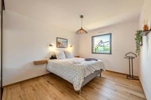 a bedroom with a bed and a window at Ti Braz Magnifique Maison Piscine in Plouguerneau +25 photos