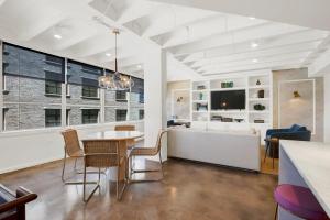 a dining room with a table and chairs and a couch at Liberty Mid-Century in Savannah