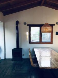 a dining room with a table and a wood stove at Casa La Tedera in El Pinar del Hierro