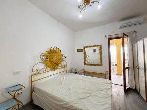 a bedroom with a bed and a mirror on the wall at La Casetta Di Lulu' in Villasimius