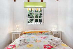 a bedroom with a bed with towels on it at Apartamento en la playa con terraza 3 in Conil de la Frontera