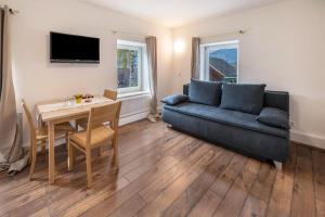 a living room with a couch and a table at Appartement Sophia in Sankt Martin +16 photos