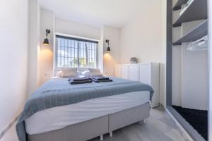 a bedroom with a large bed with a window at Casa Feliz in Mijas +16 photos