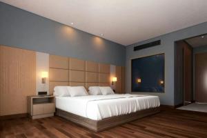 ein Schlafzimmer mit einem großen weißen Bett in einem Zimmer in der Unterkunft Four Points by Sheraton Accra Kotoka Airport in Accra