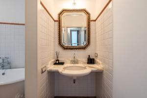 a bathroom with a sink and a mirror at Terrazza su San Miniato con garage in San Miniato +21 photos