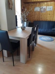 a dining room table with chairs and a vase on it at Le Gypaete Val Cenis in Termignon