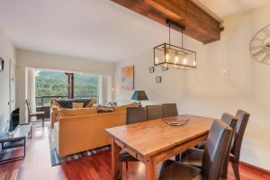 een eetkamer en een woonkamer met een houten tafel bij Apto Ideal En La Molina in Alp
