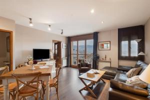 a living room with a couch and a table at Maravilloso Atico En Puigcerdà in Puigcerdà