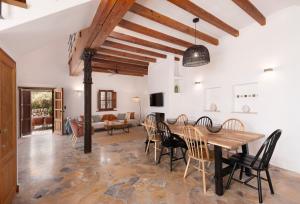 a dining room with a wooden table and chairs at Las Rocas in Fornalutx