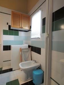 a small bathroom with a toilet and a window at L'olivier in LʼIsle-sur-la-Sorgue +22 photos