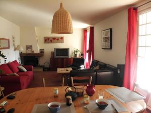 una sala de estar con una mesa y un sofá en Les Berbéris - Gîte En Ardèche, en Chandolas