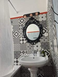 ein Badezimmer mit Waschbecken und Spiegel in der Unterkunft Casa Delia in LʼÎle-Rousse