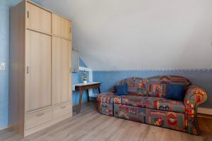 a living room with a couch and a table at Ferienhaus am Rhein in Rheinau